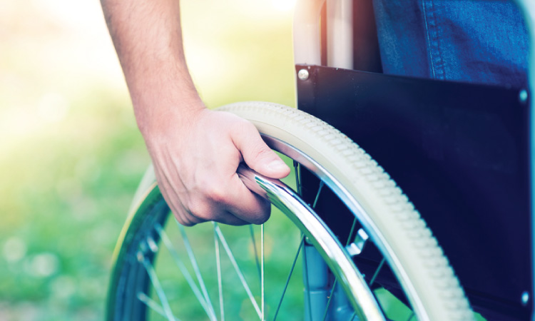Close-up of hand on wheel of a wheelchair