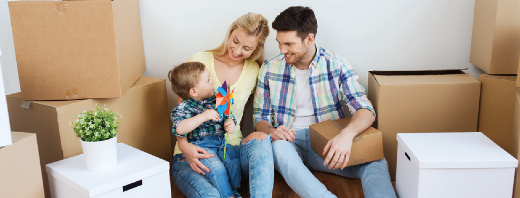 family moving into new home, boxes surrounding them